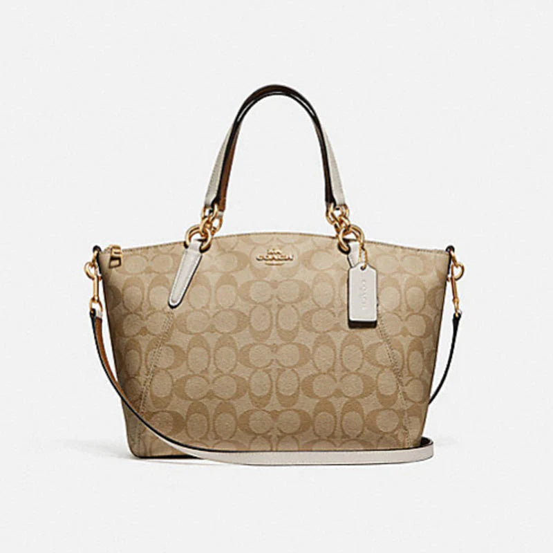 Coach tote bags with a snap - button closure and a decorative charm for styleCoach Kelsey Satchel In Signature Canvas Bag